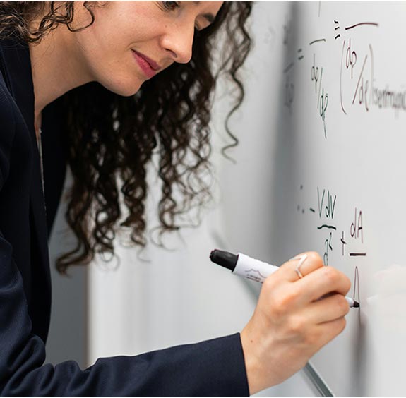 woman writing on whiteboard